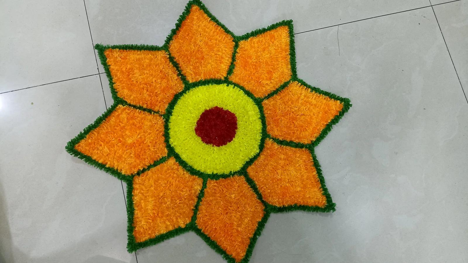Eight-Point Flower Woolen Rangoli Mat – Orange & Yellow